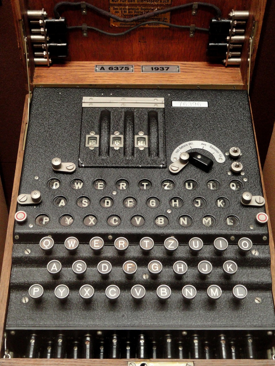 A typewriter-like machine with lots of buttons, switches, and mechanical parts.